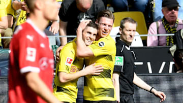 Dortmund's US midfielder Christian Pulisic and Dortmund's Polish defender Lukasz Piszczek celebrate during the German first division Bundesliga football match Borussia Dortmund vs VfB Stuttgart, in Dortmund, western Germany, on April 8, 2018. / AFP PHOTO / Patrik STOLLARZ / RESTRICTIONS: DURING MATCH TIME: DFL RULES TO LIMIT THE ONLINE USAGE TO 15 PICTURES PER MATCH AND FORBID IMAGE SEQUENCES TO SIMULATE VIDEO. == RESTRICTED TO EDITORIAL USE == FOR FURTHER QUERIES PLEASE CONTACT DFL DIRECTLY AT 49 69 650050 (Photo credit should read PATRIK STOLLARZ/AFP/Getty Images)