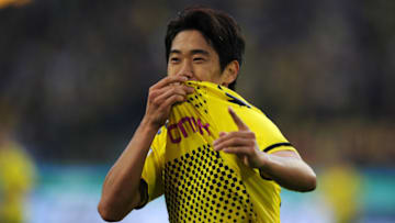 Dortmund's Japanese forward Shinji Kagawa celebrates scoring during the German first division Bundesliga football match Borussia Dortmund vs VfL Wolfsburg in the western German city of Dortmund on November 5, 2011. AFP PHOTO / PATRIK STOLLARZ +++ RESTRICTIONS / EMBARGO - DFL LIMITS THE USE OF IMAGES ON THE INTERNET TO 15 PICTURES (NO VIDEO-LIKE SEQUENCES) DURING THE MATCH AND PROHIBITS MOBILE (MMS) USE DURING AND FOR FURTHER TWO HOURS AFTER THE MATCH. FOR MORE INFORMATION CONTACT DFL. (Photo credit should read PATRIK STOLLARZ/AFP/Getty Images)