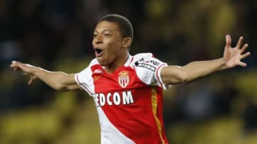 Monaco's French forward Kylian Mbappe Lottin celebrates after scoring a goal during the French L1 football match Monaco (ASM) vs Troyes (ESTAC) on February 20, 2016 at the 'Louis II Stadium' in Monaco. AFP PHOTO / VALERY HACHE / AFP / VALERY HACHE (Photo credit should read VALERY HACHE/AFP/Getty Images)