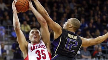 Feb 13, 2015; Seattle, WA, USA; Arizona Wildcats center Kaleb Tarczewski (35) is fouled as he goes up for a shot by Washington Huskies guard Andrew Andrews (12) during the second half at Alaska Airlines Arena. Arizona defeated Washington, 86-62. Mandatory Credit: Joe Nicholson-USA TODAY Sports