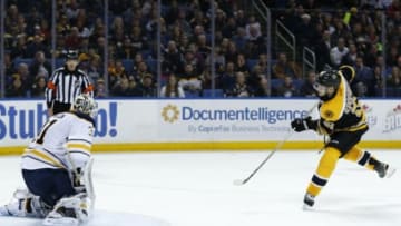 Feb 4, 2016; Buffalo, NY, USA; Boston Bruins center Ryan Spooner (51) scores the game winner on Buffalo Sabres goalie Chad Johnson (31) during a shootout at First Niagara Center. Bruins beat the Sabres 3-2. Mandatory Credit: Kevin Hoffman-USA TODAY Sports