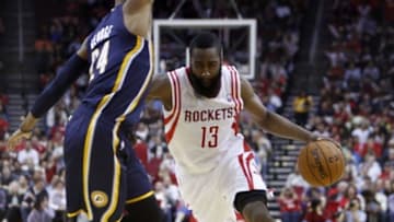 Mar 27, 2013; Houston, TX, USA; Houston Rockets shooting guard James Harden (13) drives against Indiana Pacers small forward Paul George (24) in the first half at the Toyota Center. Mandatory Credit: Thomas Campbell-USA TODAY Sports