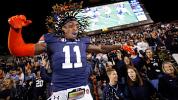 AUBURN, AL - OCTOBER 22: Markell Boston #11 of the Auburn Tigers jumps into the stands with fans after the game against the Arkansas Razorbacks at Jordan-Hare Stadium on October 22, 2016 in Auburn, Alabama. Auburn defeated Arkansas 56-3. (Photo by Joe Robbins/Getty Images)