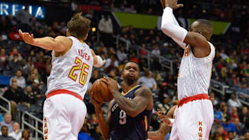 Nov 22, 2016; Atlanta, GA, USA; New Orleans Pelicans forward Terrence Jones (9) goes to the basket between Atlanta Hawks guard Kyle Korver (26) and forward Paul Millsap (4) during the first half at Philips Arena. Mandatory Credit: Dale Zanine-USA TODAY Sports