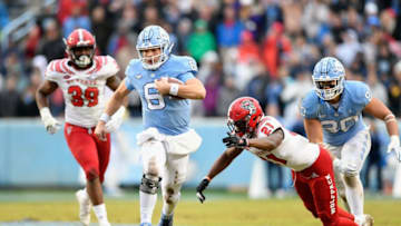 CHAPEL HILL, NORTH CAROLINA - NOVEMBER 24: Stephen Griffin #21 of the North Carolina State Wolfpack pursues Cade Fortin #6 of the North Carolina Tar Heels during the first half of their game at Kenan Stadium on November 24, 2018 in Chapel Hill, North Carolina. (Photo by Grant Halverson/Getty Images)