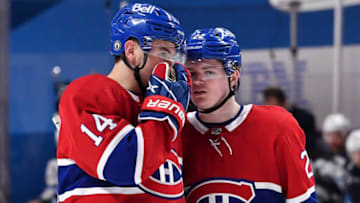 MONTREAL, QC - JUNE 06: Nick Suzuki #14 and Cole Caufield #22 of the Montreal Canadiens speak during the second period against the Winnipeg Jets in Game Three of the Second Round of the 2021 Stanley Cup Playoffs at the Bell Centre on June 6, 2021 in Montreal, Canada. (Photo by Minas Panagiotakis/Getty Images)
