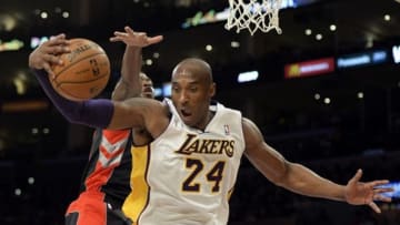 Dec 8, 2013; Los Angeles, CA, USA; Los Angeles Lakers shooting guard Kobe Bryant (24) grabs a rebound against the Toronto Raptors during the first half at Staples Center. Mandatory Credit: Richard Mackson-USA TODAY Sports