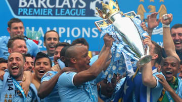 MANCHESTER, ENGLAND - MAY 11: Vincent Kompany of Manchester City lifts the Premier League trophy at the end of the Barclays Premier League match between Manchester City and West Ham United at the Etihad Stadium on May 11, 2014 in Manchester, England. (Photo by Alex Livesey/Getty Images)