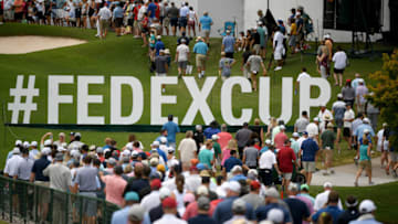 Aug 23, 2019; Atlanta, GA, USA; Patrons walk by FedEx Cup signage during the second round of the Tour Championship golf tournament at East Lake Golf Club. Mandatory Credit: Adam Hagy-USA TODAY Sports