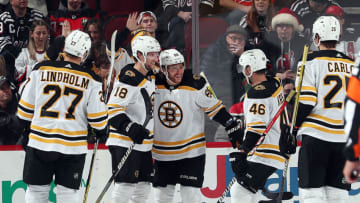 NEWARK, NEW JERSEY - DECEMBER 23: David Pastrnak #88 of the Boston Bruins is congratulated by teammates after scoring during the 2nd period of the game against the New Jersey Devils at Prudential Center on December 23, 2022 in Newark, New Jersey. (Photo by Jamie Squire/Getty Images)