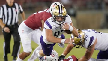 PALO ALTO, CALIFORNIA - OCTOBER 05: Cade Otton #87 of the Washington Huskies gets forced out of bounds by Curtis Robinson #2 of the Stanford Cardinal during the second quarter of an NCAA football game at Stanford Stadium on October 05, 2019 in Palo Alto, California. (Photo by Thearon W. Henderson/Getty Images)