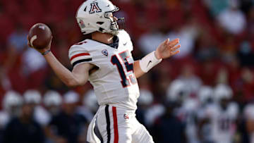 LOS ANGELES, CALIFORNIA - OCTOBER 30: Will Plummer #15 of the Arizona Wildcats passes against the USC Trojans during the first quarter at Los Angeles Memorial Coliseum on October 30, 2021 in Los Angeles, California. (Photo by Michael Owens/Getty Images)