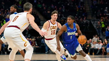 Dec 10, 2021; Minneapolis, Minnesota, USA; Minnesota Timberwolves forward Anthony Edwards (1) drives to the basket as Cleveland Cavaliers forward Cedi Osman (16) and forward Kevin Love (0) defend during the second quarter at Target Center. Mandatory Credit: Nick Wosika-USA TODAY Sports