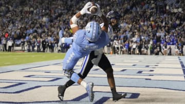 Nov 11, 2023; Chapel Hill, North Carolina, USA; North Carolina Tar Heels tight end Bryson Nesbit (18) catches a touchdown pass as Duke Blue Devils nickel Brandon Johnson (3) defends in the fourth quarter at Kenan Memorial Stadium. Mandatory Credit: Bob Donnan-USA TODAY Sports
