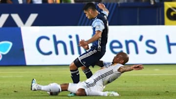 Jul 4, 2016; Carson, CA, USA; Los Angeles Galaxy midfielder Nigel de Jong (34) and Vancouver Whitecaps midfielder Matias Laba (15) battle for the ball in the first half of the game at StubHub Center. Mandatory Credit: Jayne Kamin-Oncea-USA TODAY Sports
