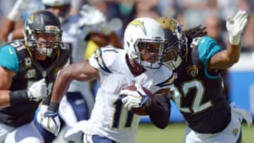 Sep 28, 2014; San Diego, CA, USA; San Diego Chargers wide receiver Eddie Royal (11) carries to ball to score a touchdown as Jacksonville Jaguars free safety Winston Guy (22) defends during the second quarter at Qualcomm Stadium. Mandatory Credit: Jake Roth-USA TODAY Sports