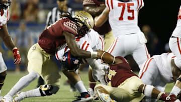 Sep 5, 2016; Orlando, FL, USA; Florida State Seminoles defensive end DeMarcus Walker (44) and defensive end Josh Sweat (9) tackle Mississippi Rebels quarterback Chad Kelly (middle) for a sack in the fourth quarter at Camping World Stadium. Florida State Seminoles won 45-34. Mandatory Credit: Logan Bowles-USA TODAY Sports