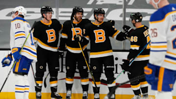 Apr 29, 2021; Boston, Massachusetts, USA; As Buffalo Sabres defenseman Henri Jokiharju (10) skates away as Boston Bruins left wing Taylor Hall (center left) celebrates his goal with defenseman Mike Reilly (6), defenseman Connor Clifton (center right) and center David Krejci (46) during the third period at TD Garden. Mandatory Credit: Winslow Townson-USA TODAY Sports
