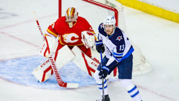 Mar 27, 2021; Calgary, Alberta, CAN; Winnipeg Jets center Pierre-Luc Dubois (13) skates in front of Calgary Flames goaltender David Rittich (33) during the first period at Scotiabank Saddledome. Mandatory Credit: Sergei Belski-USA TODAY Sports