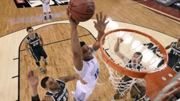 Apr 4, 2015; Indianapolis, IN, USA; Duke Blue Devils center Jahlil Okafor (15) dunks the ball against Michigan State Spartans guard Denzel Valentine (45) during the first half of the 2015 NCAA Men