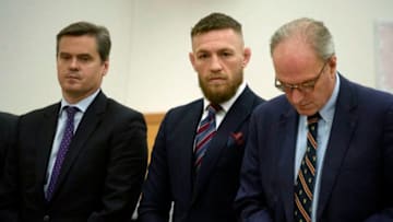 Mixed Martial Artist Conor McGregor (C) pleads guilty to disorderly conduct during a hearing at New York State Supreme Court in Brooklyn, on July 26, 2018. Others are unidentified. - McGregor had been charged with multiple counts of assault and criminal mischief after attacking a bus filled with UFC fighters at the Barclays Center. He pleaded guilty to a lesser charge of disorderly conduct in a fleeting court appearance, and was handed a punishment of five days' community service. (Photo by Charles Eckert / POOL / AFP) (Photo credit should read CHARLES ECKERT/AFP/Getty Images)