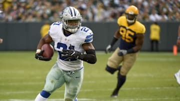 Oct 16, 2016; Green Bay, WI, USA; Dallas Cowboys running back Ezekiel Elliott (21) carries the ball past Green Bay Packers defensive end Datone Jones (95) in the second quarter at Lambeau Field. Mandatory Credit: Benny Sieu-USA TODAY Sports