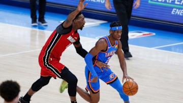 OKC Thunder guard Shai Gilgeous-Alexander (2) drives to the basket around Miami Heat center Bam Adebayo (13). Mandatory Credit: Alonzo Adams-USA TODAY Sports.