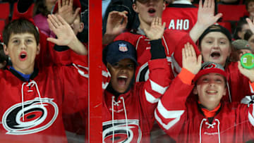 RALEIGH, NC - MARCH 4: Young Carolina Hurricanes fans bang on the glass prior to an NHL game against the Winnipeg Jets on March 4, 2018 at PNC Arena in Raleigh, North Carolina. (Photo by Gregg Forwerck/NHLI via Getty Images)