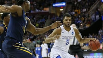 Mar 26, 2015; Cleveland, OH, USA; Kentucky Wildcats guard Andrew Harrison (5) dribbles while guarded by West Virginia Mountaineers forward Devin Williams (5) during the first half in the semifinals of the midwest regional of the 2015 NCAA Tournament at Quicken Loans Arena. Mandatory Credit: Rick Osentoski-USA TODAY Sports
