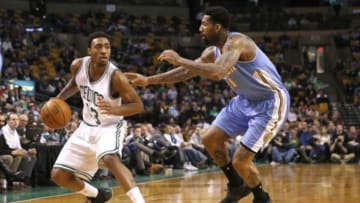 Feb 4, 2015; Boston, MA, USA; Boston Celtics shooting guard James Young (13) is guarded by Denver Nuggets guard forward Wilson Chandler (21) during the fourth quarter at TD Garden. The Boston Celtics won 104-100. Mandatory Credit: Greg M. Cooper-USA TODAY Sports