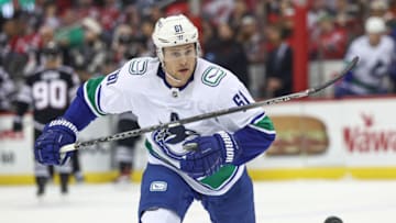 Feb 6, 2023; Newark, New Jersey, USA; Vancouver Canucks defenseman Riley Stillman (61) chases a loose puck during the first period against the New Jersey Devils at Prudential Center. Mandatory Credit: Vincent Carchietta-USA TODAY Sports