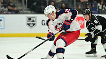 Apr 16, 2022; Los Angeles, California, USA; Columbus Blue Jackets left wing Patrik Laine (29) skates the puck past Los Angeles Kings defenseman Olli Maatta (6) in the third period at Crypto.com Arena. Mandatory Credit: Jayne Kamin-Oncea-USA TODAY Sports