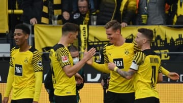 Dortmund's German forward Steffen Tigges (2ndR) is celebrated by teammates for scoring the 2-0 during the German first division Bundesliga football match Borussia Dortmund v FC Cologne in Dortmund, western Germany, on October 30, 2021. - - RESTRICTIONS: DFL REGULATIONS PROHIBIT ANY USE OF PHOTOGRAPHS AS IMAGE SEQUENCES AND/OR QUASI-VIDEO (Photo by Ina Fassbender / AFP) / RESTRICTIONS: DFL REGULATIONS PROHIBIT ANY USE OF PHOTOGRAPHS AS IMAGE SEQUENCES AND/OR QUASI-VIDEO (Photo by INA FASSBENDER/AFP via Getty Images)
