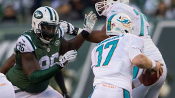 Nov 29, 2015; East Rutherford, NJ, USA; New York Jets defensive end Muhammad Wilkerson (96) chases Miami Dolphins quarterback Ryan Tannehill (17) during the second half at MetLife Stadium.The Jets defeated the Dolphins 38-20. Mandatory Credit: William Hauser-USA TODAY Sports