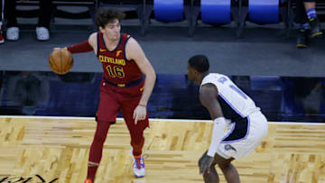 Jan 4, 2021; Orlando, Florida, USA; Cleveland Cavaliers forward Cedi Osman (16) controls the ball around Orlando Magic guard Dwayne Bacon (8) during the first quarter at Amway Center. Mandatory Credit: Reinhold Matay-USA TODAY Sports