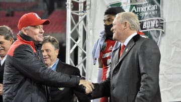 Dec 30, 2015; Nashville, TN, USA; Franklin American Mortgage president Dan Crockett welcomes Louisville Cardinals head coach Bobby Petrino to the presentation stage following the 2015 Music City Bowl against the Texas A&M Aggies at Nissan Stadium. Louisville won 27-21. Mandatory Credit: Jim Brown-USA TODAY Sports