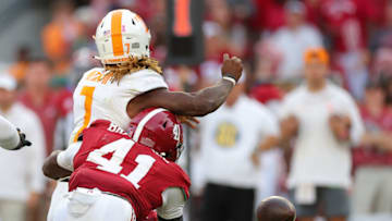 TUSCALOOSA, ALABAMA - OCTOBER 21: Chris Braswell #41 of the Alabama Crimson Tide forces a fumble by Joe Milton III #7 of the Tennessee Volunteers that resulted in a touchdown by Jihaad Campbell #30 during the fourth quarter at Bryant-Denny Stadium on October 21, 2023 in Tuscaloosa, Alabama. (Photo by Kevin C. Cox/Getty Images)
