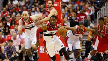 Apr 27, 2014; Washington, DC, USA; Washington Wizards guard John Wall (2) dribbles the ball in front of Wizards center Marcin Gortat (4) and Wizards forward Trevor Ariza (1) against the Chicago Bulls in game four of the first round of the 2014 NBA Playoffs at Verizon Center. Mandatory Credit: Geoff Burke-USA TODAY Sports