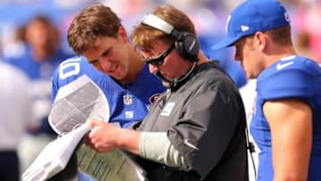 Sep 14, 2014; East Rutherford, NJ, USA; New York Giants quarterback Eli Manning (10) and offensive coordinator Ben McAdoo and New York Giants quarterback Ryan Nassib (9) looks at the playbook during the fourth quarter against the Arizona Cardinals at MetLife Stadium. The Cardinals defeated the Giants 25-14. Mandatory Credit: Brad Penner-USA TODAY Sports