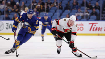 Feb 17, 2022; Buffalo, New York, USA; Buffalo Sabres center Peyton Krebs (19) and Ottawa Senators left wing Brady Tkachuk (7) go after a loose puck during the third period at KeyBank Center. Mandatory Credit: Timothy T. Ludwig-USA TODAY Sports