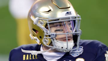 CHARLOTTE, NORTH CAROLINA - DECEMBER 19: Quarterback Ian Book #12 of the Notre Dame Fighting Irish warms up on the sideline in the first half against the Clemson Tigers during the ACC Championship game at Bank of America Stadium on December 19, 2020 in Charlotte, North Carolina. (Photo by Jared C. Tilton/Getty Images)