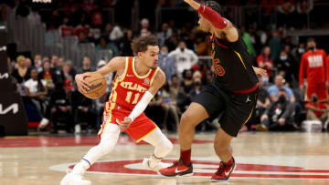Feb 15, 2022; Atlanta, Georgia, USA; Atlanta Hawks guard Trae Young (11) dribbles against Cleveland Cavaliers forward Isaac Okoro (35) during the second half at State Farm Arena. Mandatory Credit: Jason Getz-USA TODAY Sports
