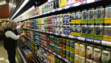 LITTLETON, CO - DECEMBER 13: Tom Dodson, Safeway liquor department manager, organizes beer from local Colorado breweries on December 13, 2018 in Littleton, Colorado. Colorado is allowing grocery stores to sell full potency beer after the new year. Stores are phasing out much of their 3.2 beer stock to accommodate for full strength beer. This Safeway, located at 181 W. Mineral Ave, currently carries a full selection of full strength and craft beer showing what customers can expect next year. The store offers 24 linear feet of locally crafted Colorado beers. (Photo by Helen H. Richardson/The Denver Post via Getty Images)