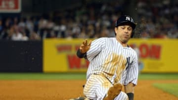 Jun 19, 2014; Bronx, NY, USA; New York Yankees second baseman Brian Roberts (14) steals third during the sixth inning against the Toronto Blue Jays at Yankee Stadium. Mandatory Credit: Anthony Gruppuso-USA TODAY Sports