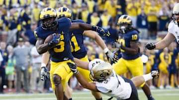 Sep 17, 2016; Ann Arbor, MI, USA; Michigan Wolverines linebacker Jabrill Peppers (5) breaks a tackle by Colorado Buffaloes tight end Chris Bounds (43) in the second half at Michigan Stadium. Michigan won 45-28. Mandatory Credit: Rick Osentoski-USA TODAY Sports