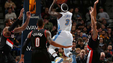 DENVER, CO - NOVEMBER 12: Ty Lawson #3 of the Denver Nuggets takes a shot against the defense of LaMarcus Aldridge #12, Damian Lillard #0 and C.J. McCollum #3 of the Portland Trail Blazers at Pepsi Center on November 12, 2014 in Denver, Colorado. The Trail Blazers defeated the Nuggets 130-113. NOTE TO USER: User expressly acknowledges and agrees that, by downloading and or using this photograph, User is consenting to the terms and conditions of the Getty Images License Agreement. (Photo by Doug Pensinger/Getty Images)