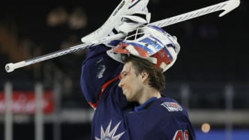 NEW YORK, NEW YORK - FEBRUARY 28: Alexandar Georgiev #40 of the New York Rangers puts one his helmet after receiving treatment for an injury during the first period against the Boston Bruins at Madison Square Garden on February 28, 2021 in New York City. (Photo by Sarah Stier/Getty Images)