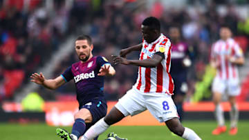 STOKE ON TRENT, ENGLAND - FEBRUARY 23: Mame Biram Diouf of Stoke City is tackled by Conor Hourihane of Aston Villa during the Sky Bet Championship match between Stoke City and Aston Villa at Bet365 Stadium on February 23, 2019 in Stoke on Trent, England. (Photo by Nathan Stirk/Getty Images)
