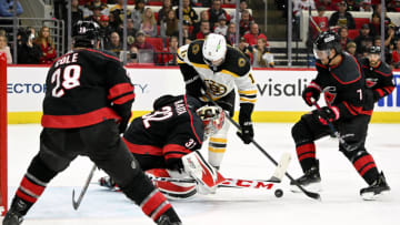 RALEIGH, NORTH CAROLINA - MAY 02: Antti Raanta #32 of the Carolina Hurricanes stops a shot by Trent Frederic #11 of the Boston Bruins during the third period of Game One of the First Round of the 2022 Stanley Cup Playoffs at PNC Arena on May 02, 2022 in Raleigh, North Carolina. The Hurricanes won 5-1. (Photo by Grant Halverson/Getty Images)