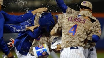 May 18, 2015; New York City, NY, USA; New York Mets left fielder John Mayberry Jr. (44) is showered with water and sunflower seeds to celebrate the New York Mets 2-1 win over the St. Louis Cardinals after his game winning single in the 14th inning at Citi Field. Mandatory Credit: Noah K. Murray-USA TODAY Sports
